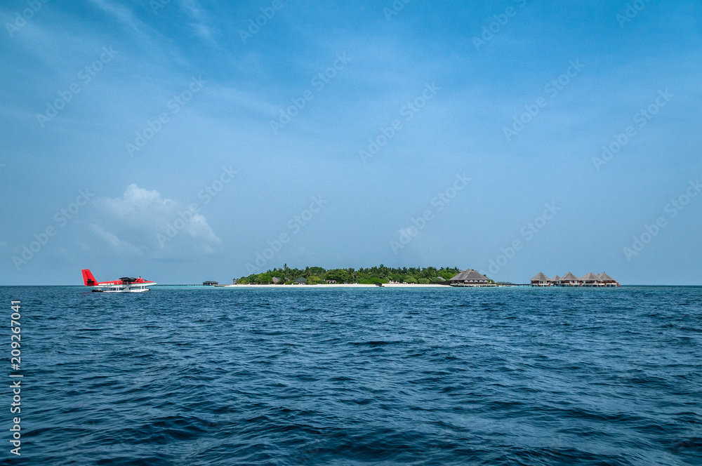 Maldives seaplane beautiful beach background white sandy tropical paradise island with blue sky sea water ocean	