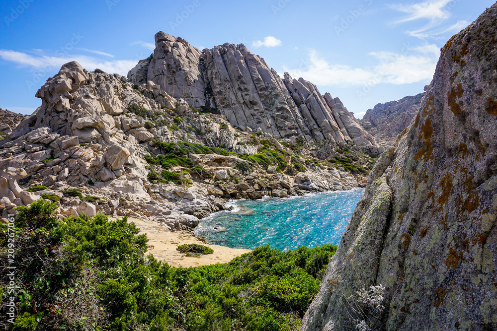 Small rocky bay with amazing turquoise water. Capo Testa, Sardinia, Italy