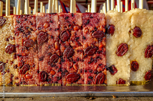 Snack Street in Beijing China. Famous Beijing street food glutinous rice stick, cooked rectangle purple rice cake. photo