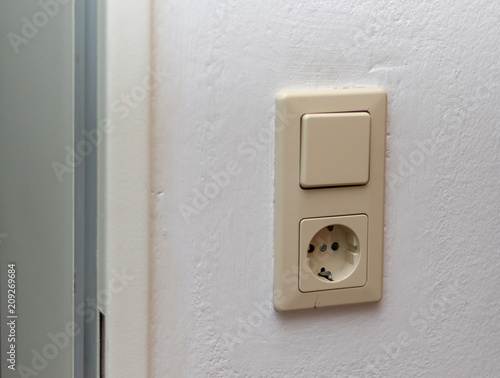 Single wall socket on a white wall