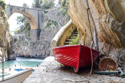 Fiordo di Furore beach. Furore Fjord Amalfi Coast Positano Naples Italy. - Fishermen colored boats on the beach, under the bridge of the fjord. The turquoise water of the beach.