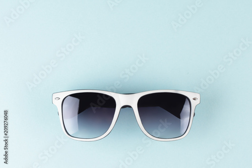 Sunglasse with blue background. Vacation minimalistic concept. Copy space