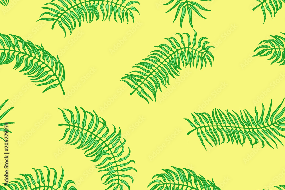 Tropical pattern. Palm leaves on the yellow background