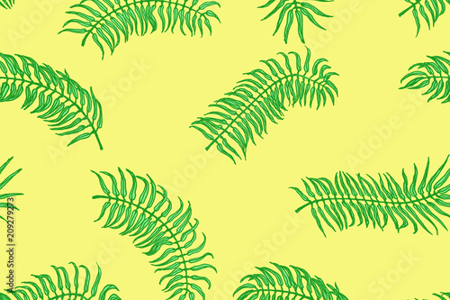 Tropical pattern. Palm leaves on the yellow background