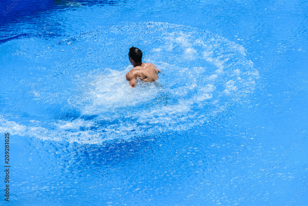 Man swimming in pool in summer