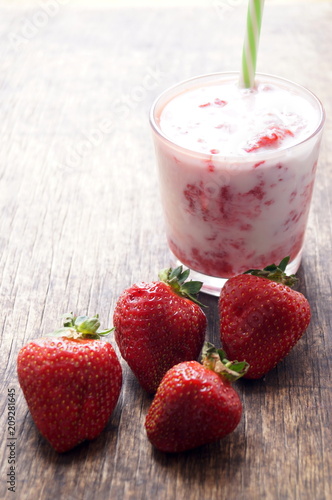 Fresh strawberry cocktail milkshake on a wooden background. Healthy food for breakfast and snacks.