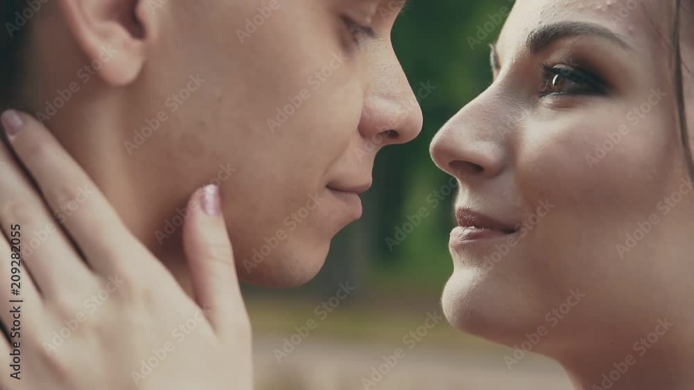 Adorably attractive couple kiss each other. Close up shot in slow motion Adorably attractive couple kiss each other. Close up shot in slow motion