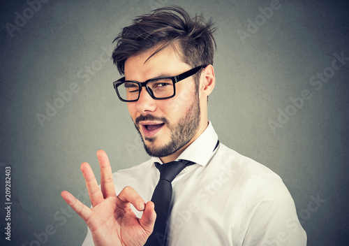 Ironic man showing OK gesture photo