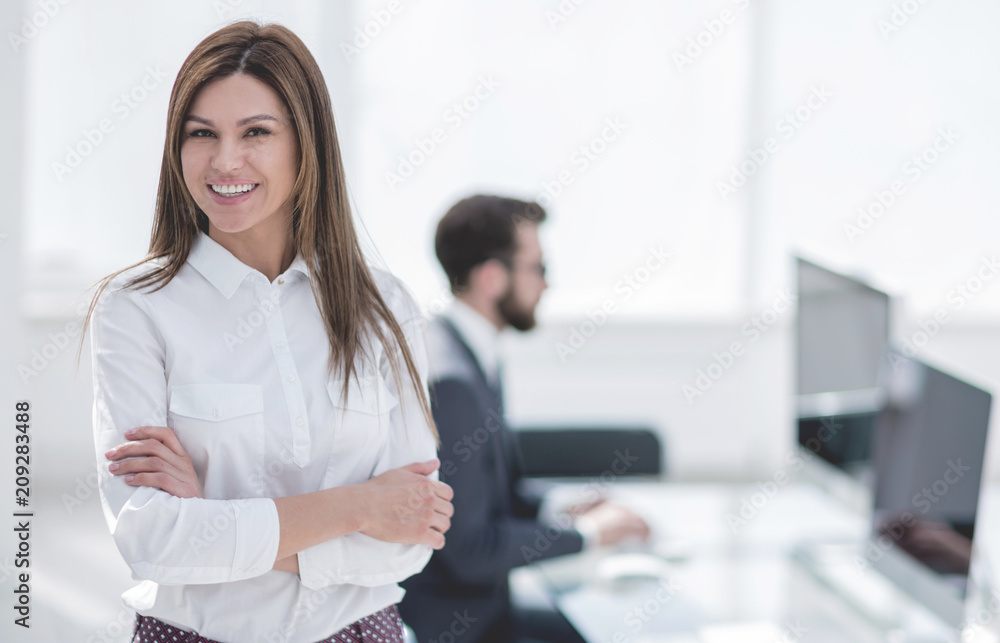 smiling business woman on the background of the workplace. smiling business woman on the background of the workplace.