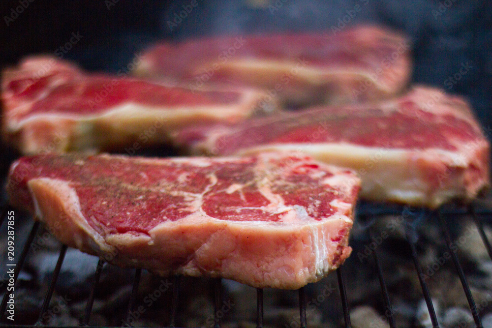 Steak Cooking On An Open Grill