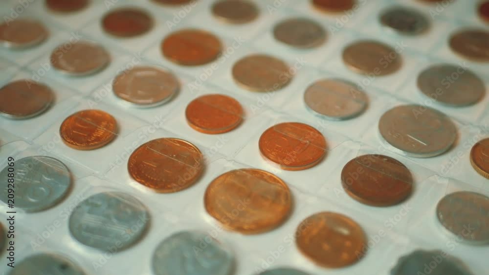 Page of numismatics album with different coins isolated. Coin album collection from different countries. Page of numismatics album with different coins isolated. Coin album collection from different countries.