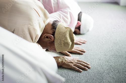 Muslim people praying in Sujud posture photo