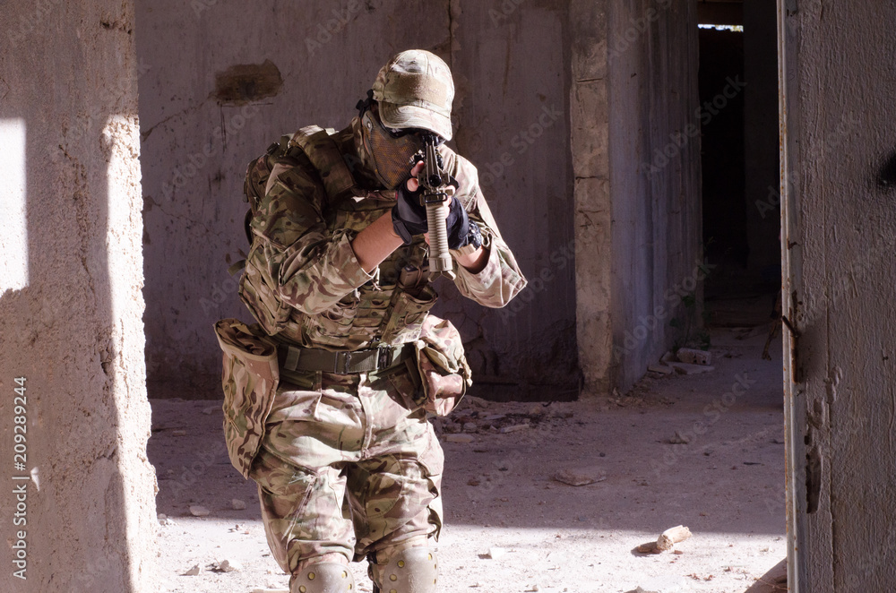 Fototapeta premium Airsoft soldier inside building Airsoft soldier inside building hold on hands rifle aim camera