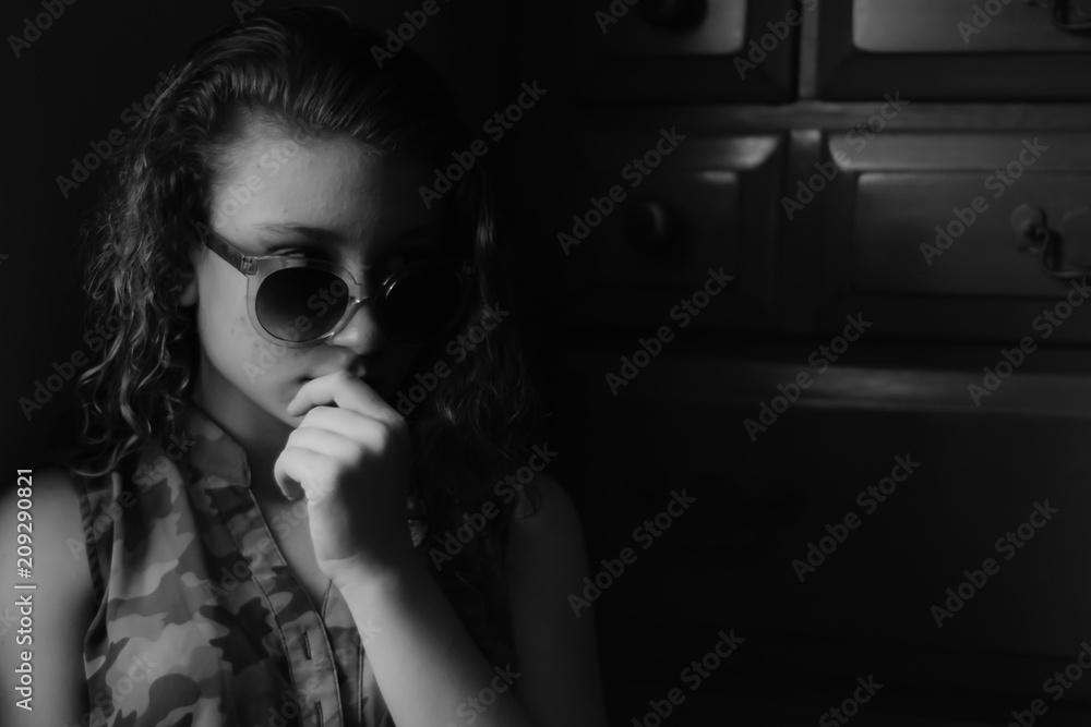 Young girl looking serious with sunglasses on Young girl looking serious with sunglasses on