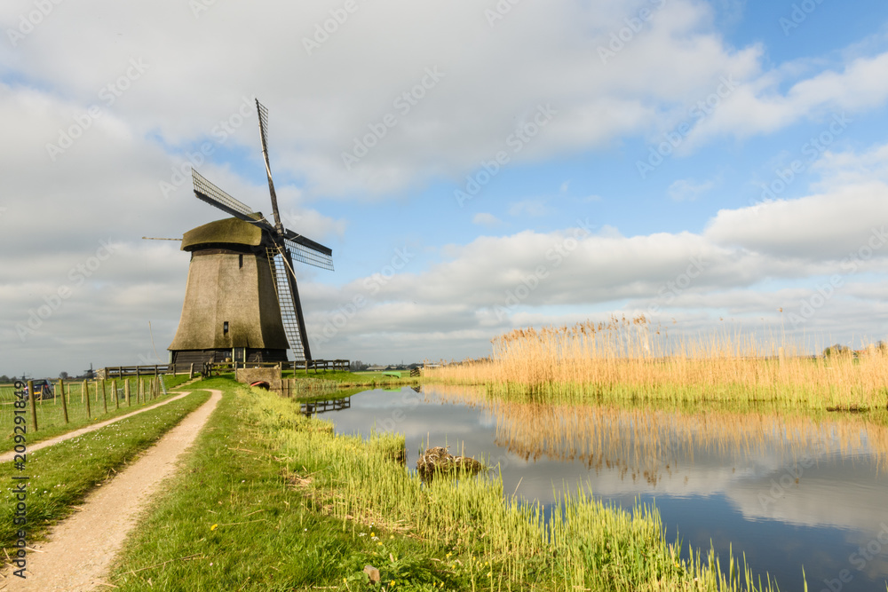 Windmill on canal in West Friesland, Netherlands