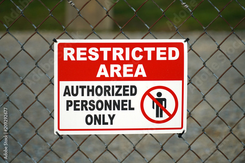 close up on restricted area sign on the iron fence photo