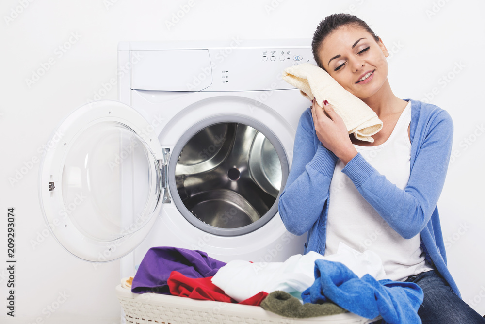 Woman with clothes in hands after washing. Woman with clothes in hands after washing.