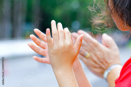 Clapping Young Girl by supporters as reaches the finishing line of a running race