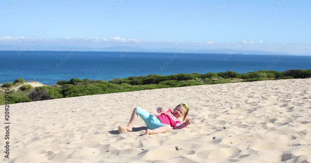 four years old blonde happy girl trying to do the somersault or handstand on sand dune, in Valdevaqueros Beach, Tarifa, Cadiz, Andalusia, Spain, Europe
four years old blonde happy girl trying to do the somersault or handstand on sand dune, in Valdevaqueros Beach, Tarifa, Cadiz, Andalusia, Spain, Europe
