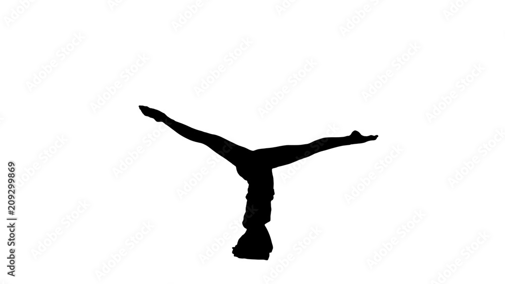 Young woman doing sirsasana yoga pose track matte