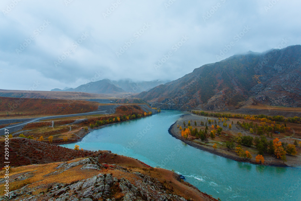 River in the mountains in cloudy weather. Place of the confluence of the rivers Katun and Chuya in Altai mountains. Siberia, Russia.