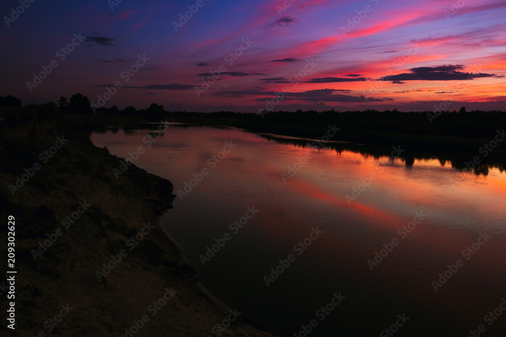 Sunset on the river with colorful reflections in the sky