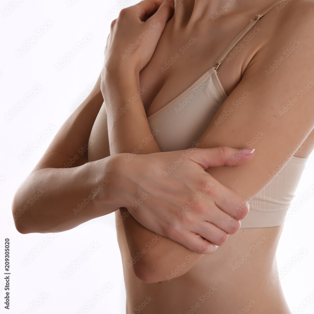 Mid section view of woman touching elbow feeling pain Mid section view of woman touching elbow feeling pain