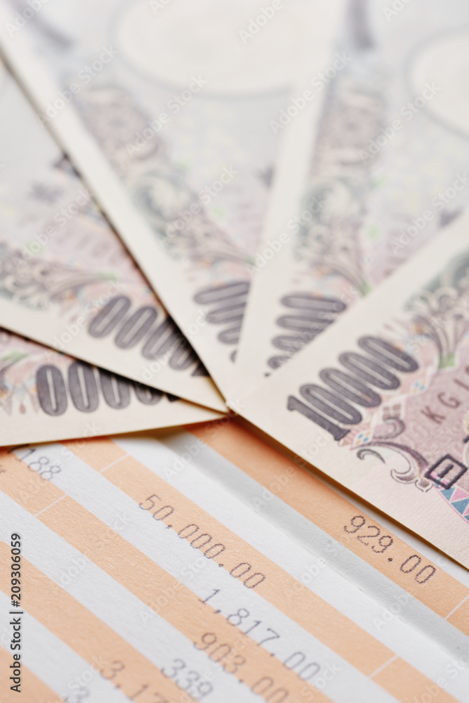 Close up saving account passbook and new Japanese yen Close up saving account passbook and new Japanese yen