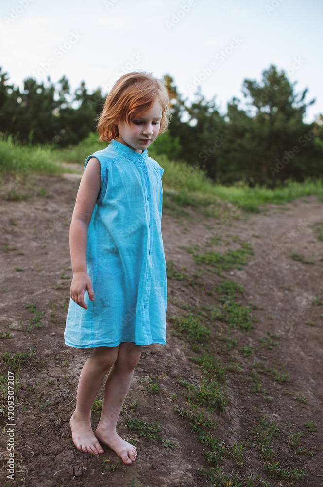 Barefoot girl in blue dress in the forest Barefoot girl in blue dress in the forest