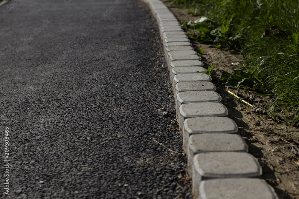 Asphalt sidewalk with curb, pavement edge