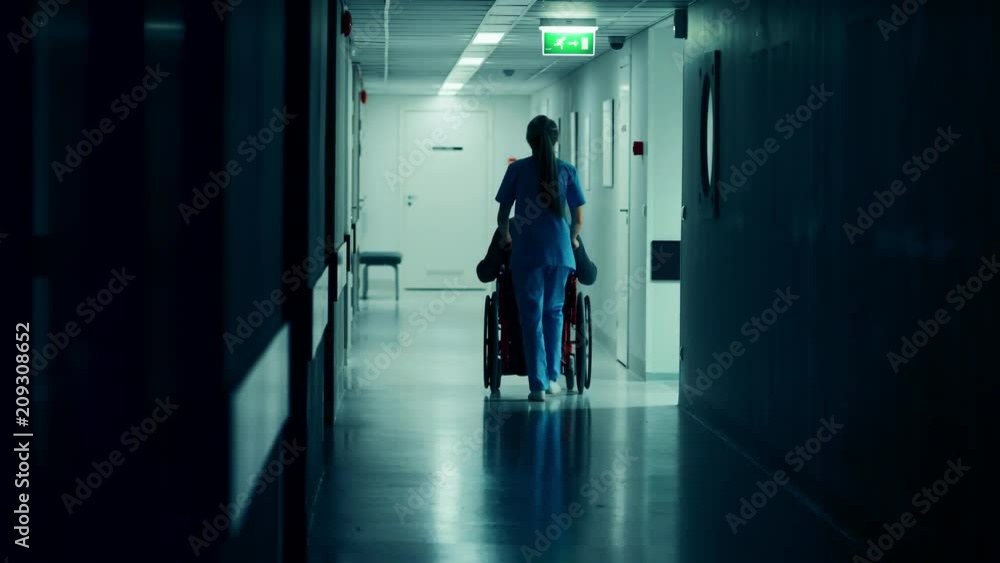 Female Nurse Pushing Patient in the Wheelchair Through the Hospital Corridor, They are Going to the Procedures. Bright Modern Hospital with Friendly Staff. Shot on RED EPIC-W 8K Helium Cinema Camera. Female Nurse Pushing Patient in the Wheelchair Through the Hospital Corridor, They are Going to the Procedures. Bright Modern Hospital with Friendly Staff. Shot on RED EPIC-W 8K Helium Cinema Camera.
