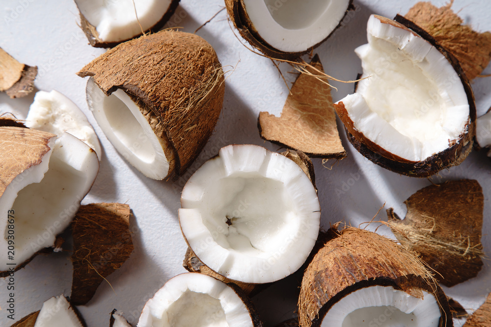 Close up image of cracked coconut on gray background Close up image of cracked coconut on gray background