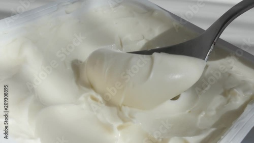 Close-up taking with creme cheese metallic spoon 4K footage