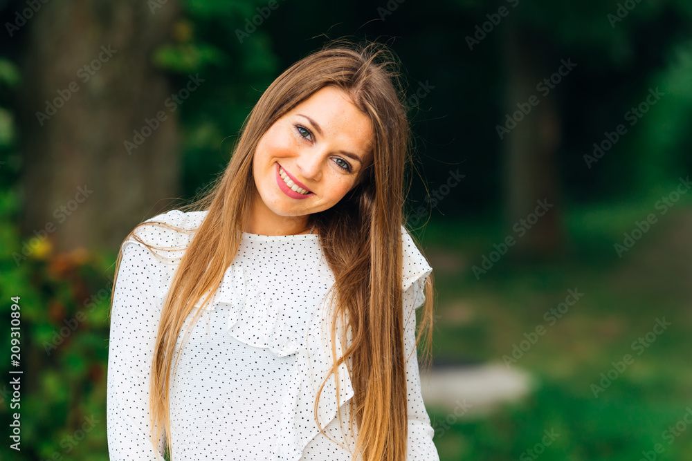 pretty girl tilted to the side of the head and looks at the camera lens pretty girl tilted to the side of the head and looks at the camera lens
