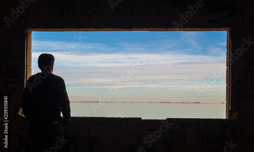 Person looking through the window at the landscape