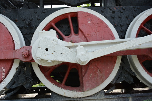 Old train made of iron made during the Second World War in black with white and red wheels on the background of nature photo