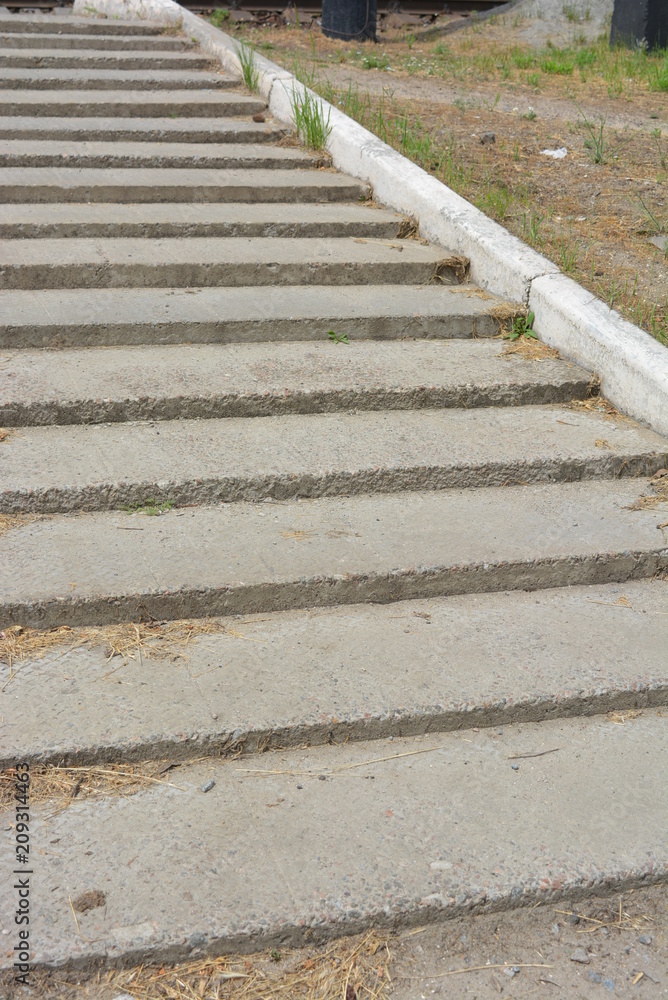 Concrete steps with concrete curb and with dry grass Concrete steps with concrete curb and with dry grass