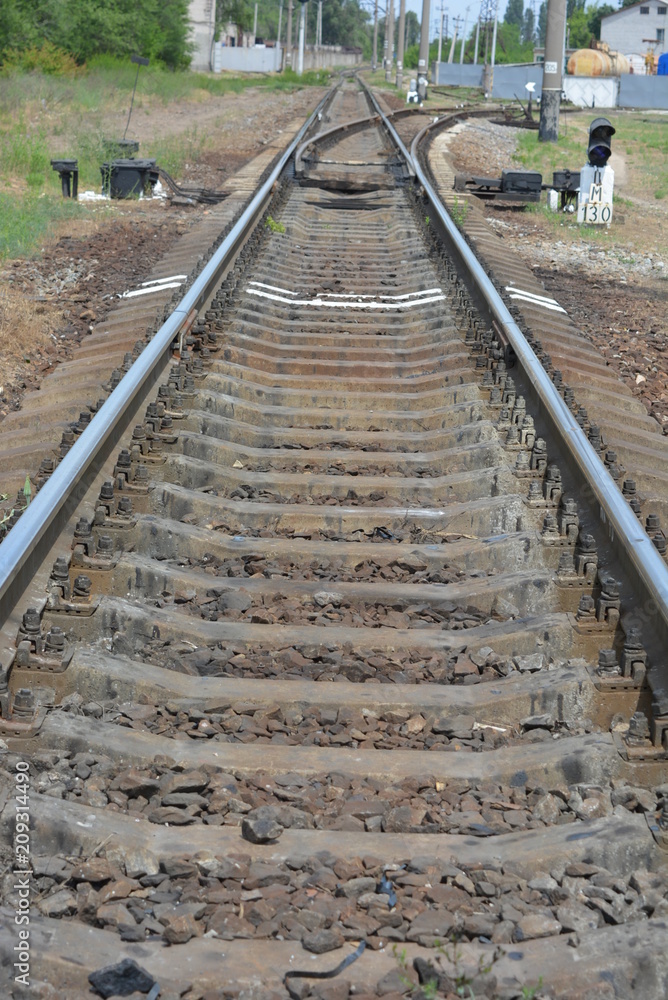 Railway track with branching and white marking in front of it Railway track with branching and white marking in front of it