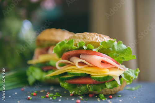 Two sandwiches with ham and cheese on the table, selective focus