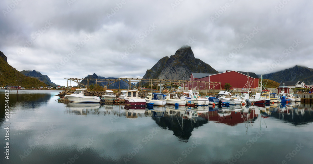 Fishing boats at the port of Reine village on Lofoten islands in Norway Fishing boats at the port of Reine village on Lofoten islands in Norway