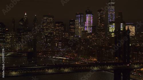 AERIAL: The two bridges lit up at night connecting Brooklyn & downtown Manhattan © helivideo