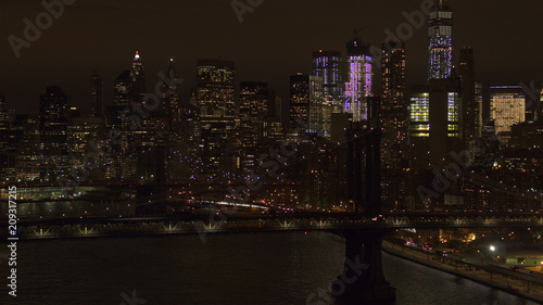 AERIAL: The two bridges lit up at night connecting Brooklyn & downtown Manhattan © helivideo