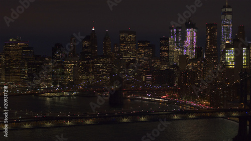 AERIAL: Dense traffic on Brooklyn Bridge interchange overpass underpass at night © helivideo