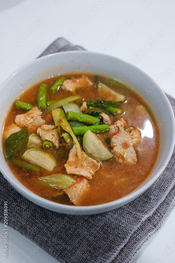 Hot Spicy curry with pork in white blow Hot Spicy curry with pork in white blow