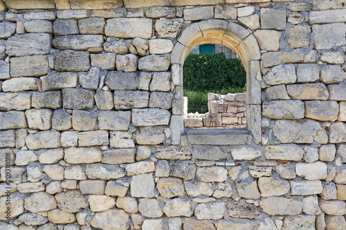 wall with a window in the ruins of an ancient city overlooking the wall with a door  selective focus