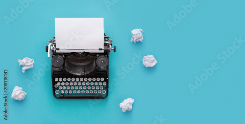 Vintage typewriter over blue background with copy space photo