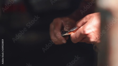 Man sharpening pencil before working. Man's hand