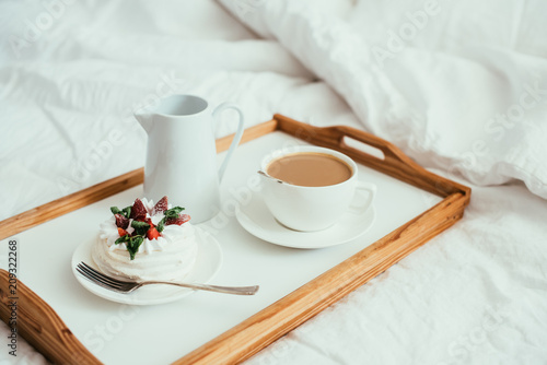 Cozy home breakfast in bed in white bedroom interior 