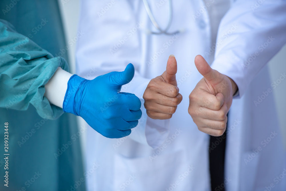 Doctor And Medical Team Showing Thumb Up Together at the Hospital. Doctor And Medical Team Showing Thumb Up Together at the Hospital.