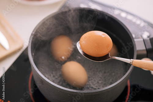 Εκτύπωση καμβά Chef putting boiled eggs in cup / Cooking sweet brown Stewed pork gravy (Moo Pa-